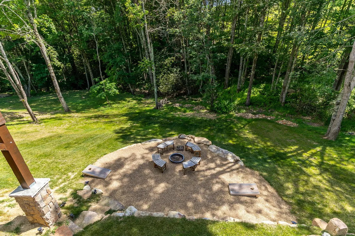 A cozy fire pit area surrounded by seating and trees, inviting families and friends to gather in the evenings. The warm glow of the fire contrasts with the cool outdoors, evoking a sense of togetherness and relaxation after a day of adventure.